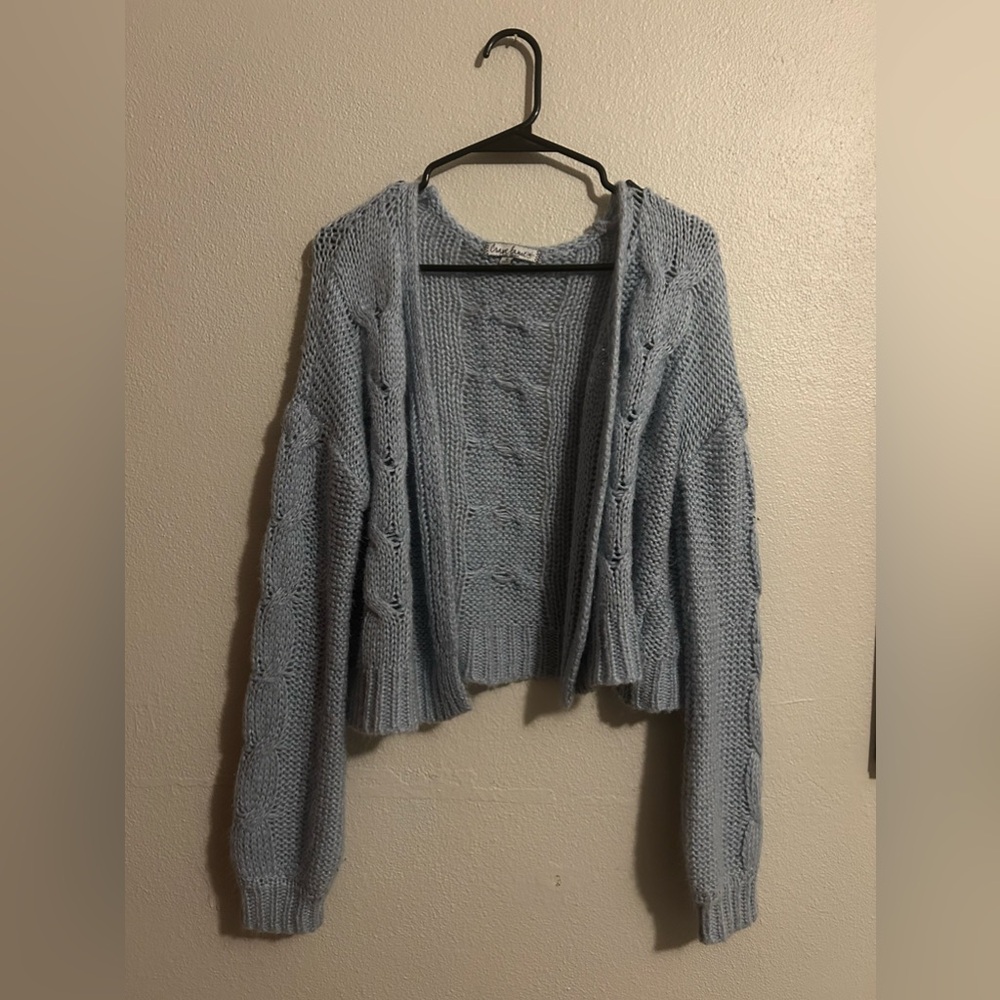 Light blue cardigan.